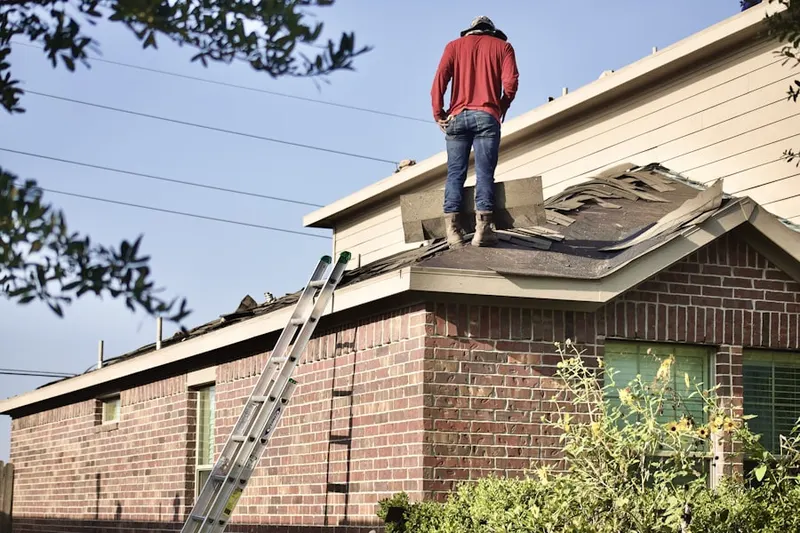 Professional roofer working on a residential roof in Westphalia